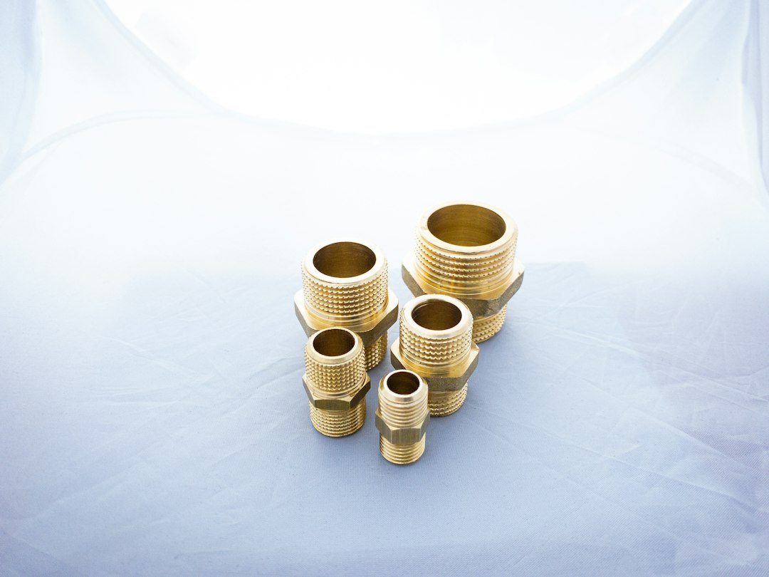 Close-up of brass metal pipe fittings, illustrating the brass scrap buying category